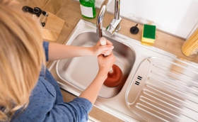 woman plunging sink 